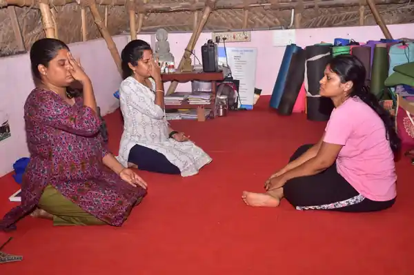 Students practising pranayama breathing